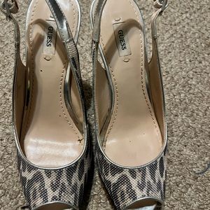 Guess, size 7, peep toe, with buckle strap on heel. Silver with leopard print.